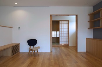 Living area with TV shoves on the left, bookshelves on the right and piano room and the Japanese room sliding doors opened.   Living area with TV shoves on the left, bookshelves on the right and piano room and the Japanese room sliding doors opened.